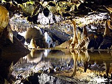 The caves in Cheddar Gorge inspired Tolkien's Glittering Caves of Aglarond, at the head of the gorge of Helm's Deep. Miniature reflections in Gough's Cave - geograph.org.uk - 1232463.jpg