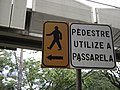 Un cartello a Belo Horizonte , Brasile , che indirizza i pedoni verso un cavalcavia per un attraversamento sicuro.
