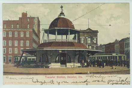 Trolley transfer station in its original location at the intersection of Main and Main streets; from a postcard sent in 1906