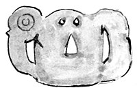 A greenstone manaia - a flat, rounded ornament with two eyes and arm-like pieces on each side.