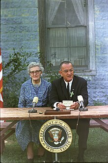 Lyndon B. Johnson at the ESEA signing ceremony, with his childhood schoolteacher Ms. Kate Deadrich Loney President Lyndon B. Johnson signs the Elementary and Secondary Education Act - C148-92-WH65.jpg