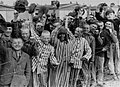 Liberated Dachau camp prisoners cheer U.S. troops