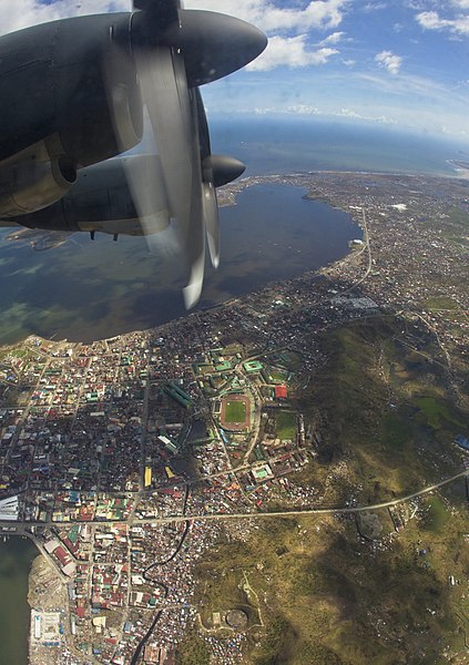 File:RAAF C-130J Hercules flies over the city of Tacloban (10916806943).jpg