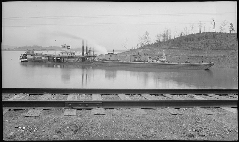 File:River channel improvement, barge unloading at Gulf Refining Company - NARA - 280795.jpg