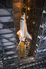 Atlantis is lowered toward the External Tank and the Solid Rocket Boosters.