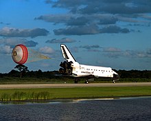 Atlantis lands on Runway 15 of the KSC Shuttle Landing Facility at the end of the STS-86 mission. STS86 Landing.jpg