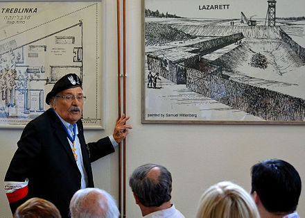 Survivor Samuel Willenberg presenting his drawings of Treblinka II in the Museum of Struggle and Martyrdom at the site of the camp. On the right, the "Lazarett" killing station.