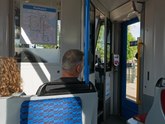 Sightseeing tour Amsterdam city by tram. The couple of Italian tourists are sitting in the front part of the tram, just behind the driver. free photo Amsterdam - Fons Heijnsbroek, July 2022