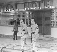 April 1942. US military police outside the Central Hotel, Brisbane. Later that year there was violence between Australians and US MPs in the Battle of Brisbane. The pipe on which they are resting their feet carried sea water, for use in fighting fires in the event of air raids. Slq picqld-2003-02-03-14-42.jpg U.S.MPs brisbane.jpg