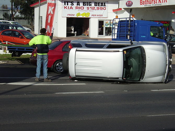 Small SUV on its side after an accident on the...
