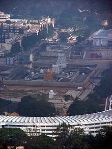 Tirumala Temple and Vaikuntam Queue Complex (semicircular building in the foreground) as seen from Srivari Padalu on Narayanagiri hill Tirumala overview.jpg