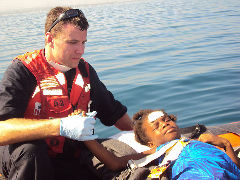 File:U.S. Coast Guard Member Gives Aid to Haitian Refugee DVIDS241442.jpg