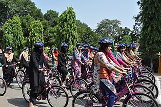 Female agriculture students in Faisalabad, Pakistan, ride donated bicycles around campus. USAID Presents 200 Bicycles to University of Agriculture under Gender Equity Program (29481517861).jpg