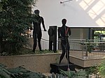 Sheet steel figures of a glass blower and a glassmaker at the glass furnace by Peter Maria Stajkoski, 1993