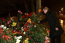 Putin in Volgograd, 1 January 2014 Vladimir Putin vozlogaet tsvety na meste vzryva trolleibusa v Volgograde.jpeg