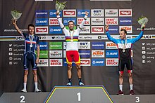 The podium after the men's elite road race, with Romain Bardet, Alejandro Valverde and Michael Woods (from left to right) 20180930 UCI Road World Championships Innsbruck Men Elite Road Race Award Ceremony 850 2142.jpg
