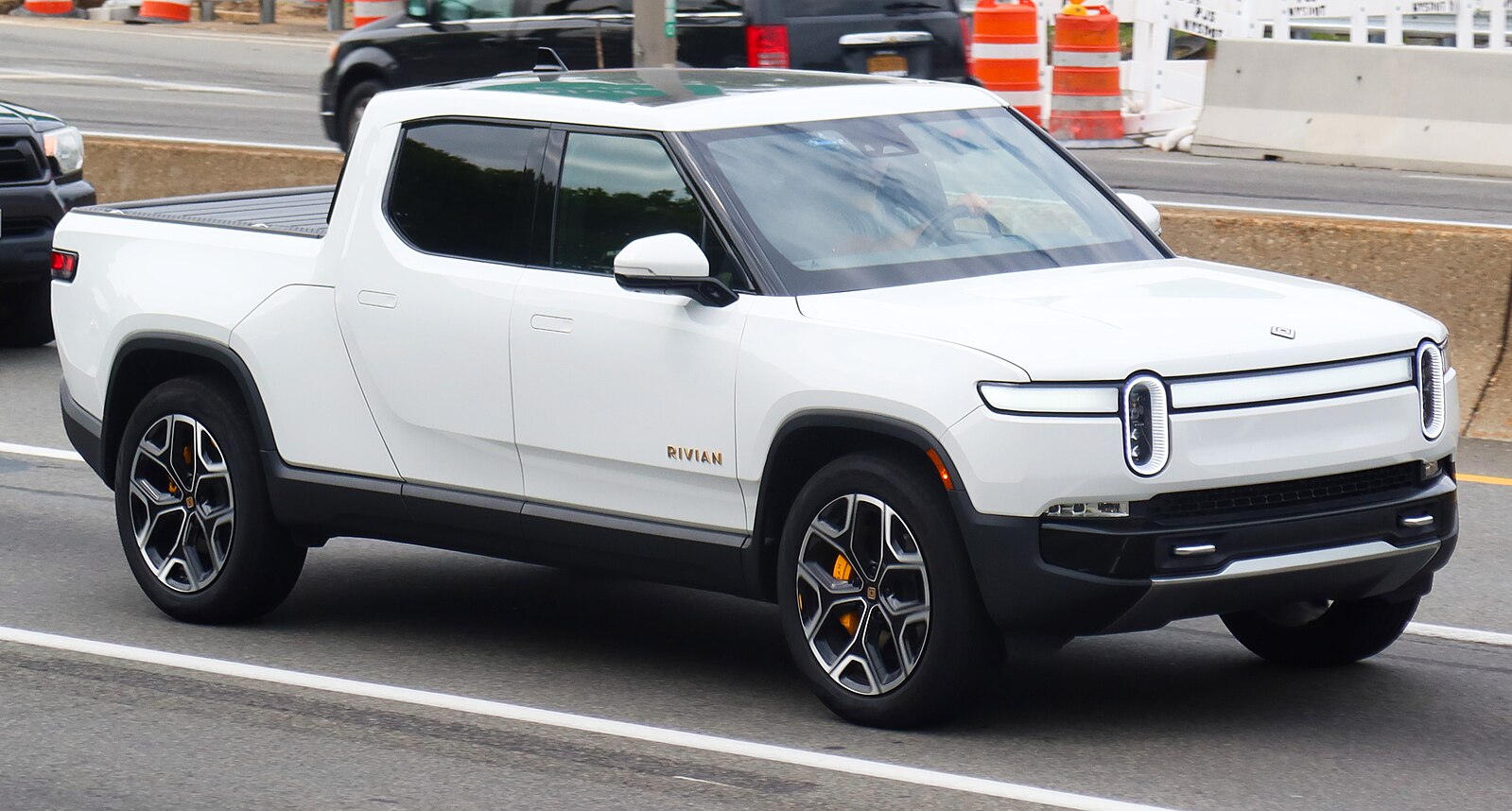 White Rivian on a street