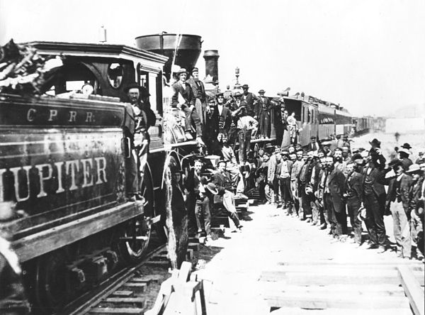 Celebration of completion of the Transcontinental Railroad, May 10, 1869, showing the name Jupiter on the side of the tender