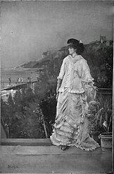 Portrait de femme en pied sur une terrasse au bord de la mer