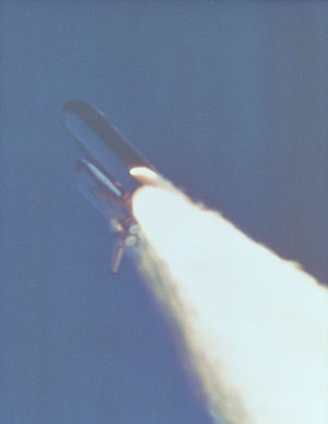 Space Shuttle challenger in-flight with an anomalous plume of fire from the side of its right solid rocket booster