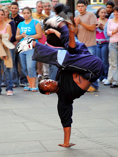 Street dance – a Breakdancer performs a handstand trick.