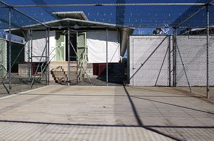 A Camp Delta recreation and exercise area in Guantánamo Bay, Cuba. The detention block is shown with sunshades drawn on 3 December 2002.