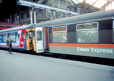Two Class 309 (AM9) units; one in NSE livery, the other in Jaffa Cake livery
