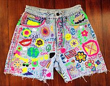 Acid washed jean shorts with grunge and hippie inspired DIY slogans and pictures. Customised cut-off denim shorts with peace symbols and slogans, American, 1990s.jpg