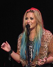 Demi Lovato topped the chart twice in 2015 with
"Cool for the Summer" and "Confident". Demi Lovato smiling and singing closeup.JPG
