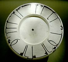 Dish with epigraphic decoration. The Kufic inscription reads: "Magnanimity has first a bitter taste, but at the end it tastes sweeter than honey. Good health [to the owner]." Terracotta, white slip ground and slip underglaze decoration, Nishapur, Khorasan (Iran), 11th-12th century. Dish epigraphic Louvre AA96.jpg