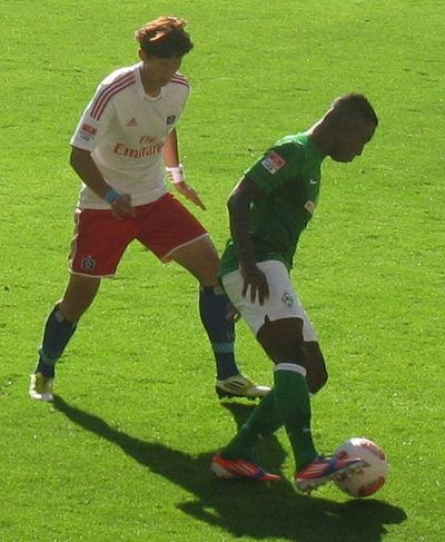 Son Heung-min of Hamburger SV against Eljero Elia of Werder Bremen in the Nordderby