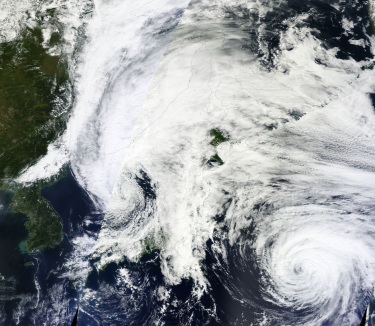 Etau as an extratropical cyclone over the Sea of Japan on September 10 with a frontal boundary extending from the cyclone across eastern Honshu. Severe Tropical Storm Kilo can be seen to the southeast of Ex-Etau. Etau and Kilo 2015-09-10 0110z.png