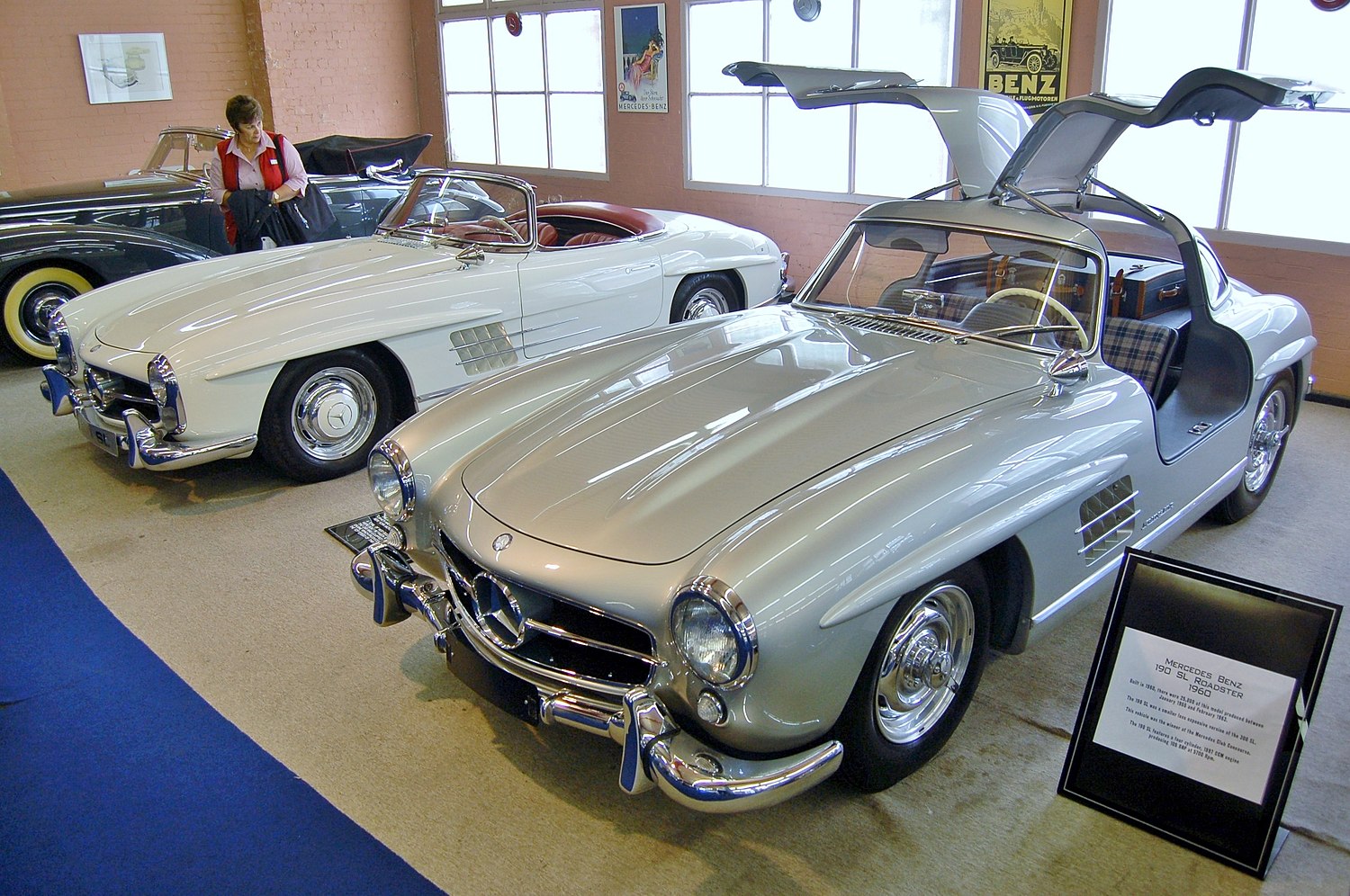 A Silver Grey Mercedesbenz 300sl Gullwing Racing On The Tracks