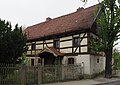 Former  Stable house, two barns and courtyard entrance (two gate pillars)