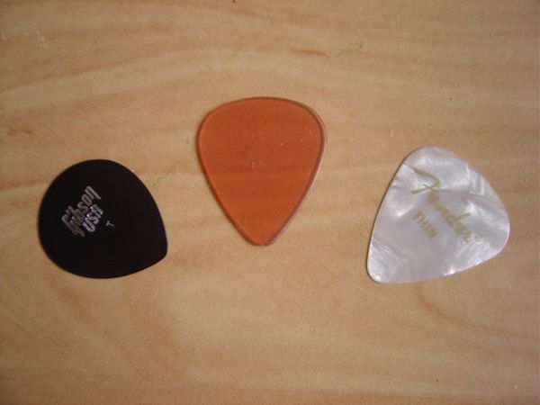 Three plectra for use with guitar
