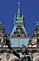 Deutsch: Hygieia auf dem Hygiea-Brunnen im Innenhof des Hamburger Rathauses in Hamburg-Altstadt, im Hintergrund der Rathausturm. This is a photograph of an architectural monument. It is on the list of cultural monuments of Hamburg, no. 11978 This is a photograph of an architectural monument. It is on the list of cultural monuments of Hamburg, no. 12066