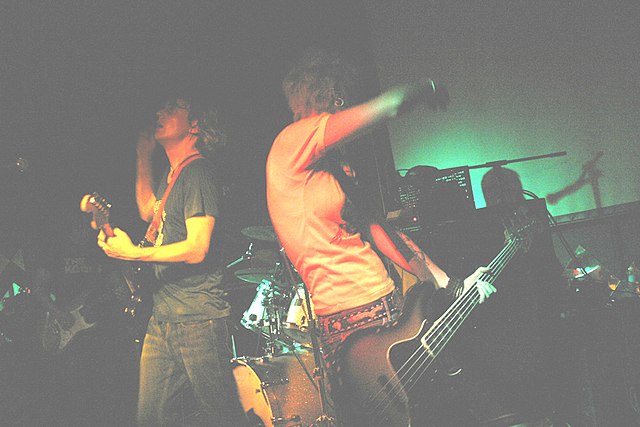 Jebediah, performing in November 2007. Left to right: Daymond (darkened), Kevin Mitchell, Brett Mitchell (obscured behind his drum kit), Vanessa Thorn