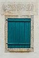 English: Window with closed shutters and vers from the Bible above Deutsch: Fenster mit geschlossenem Fensterladen und Bibelvers darüber