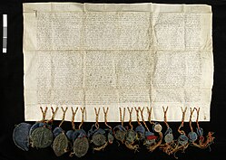 Medieval parchment letter hung with multiple seals.