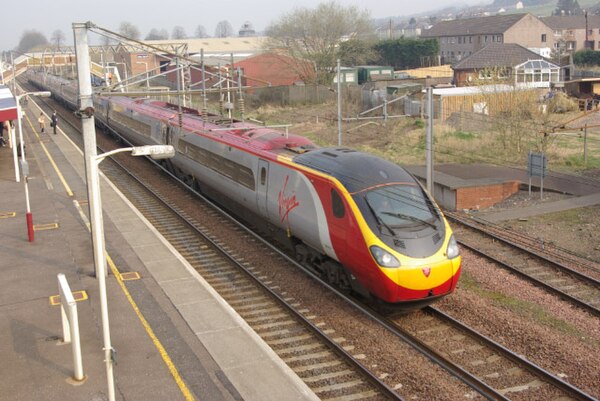 A Virgin Pendolino leaving Lockerbie station for Carlisle