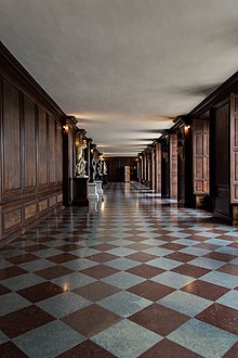 A long corridor in Hampton Court Palace. Here the Guard lined along the walls, forming a security cordon as the King passed. Long Corridor inside Hampton Court Palace.jpg