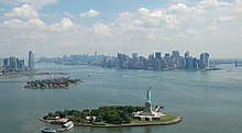 Liberty Island, with Ellis Island, downtown Jersey City (left), and Manhattan (right) in background