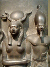 Close-up of a triad statue depicting the pharaoh Menkaura being held by the goddess Hathor MekauraHeldByGoddessHathor MuseumOfFineArtsBoston.png