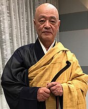 Niho Tetsumei Roshi, pictured wearing priest's robes