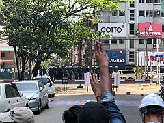 27. feruar, folk viser trefinger-symbol til politiet i Yangon.