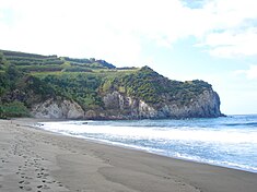 The beach and cliffs of the Praia dos Moinhos, one of the few white-sand beaches on the island of Sao Miguel SMG RBG PFo praiaPortoFormoso sand.jpg