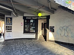 Photograph of the exterior of a building with a front entryway and window