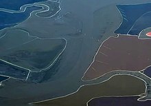 Ogilvie Island (at center) mostly submerged by water, as seen from the northeast in a 2019 aerial photo