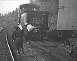 Robbers running away from train with bags