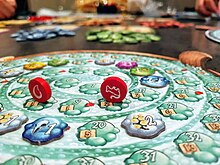 A pot player board with tokens placed along the spiral potion track The Quacks of Quedlinburg.jpg